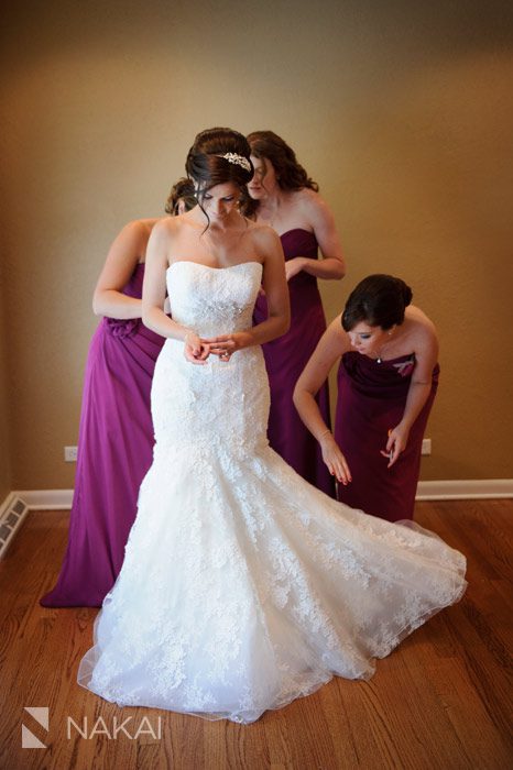 bride putting on her dress wedding photo