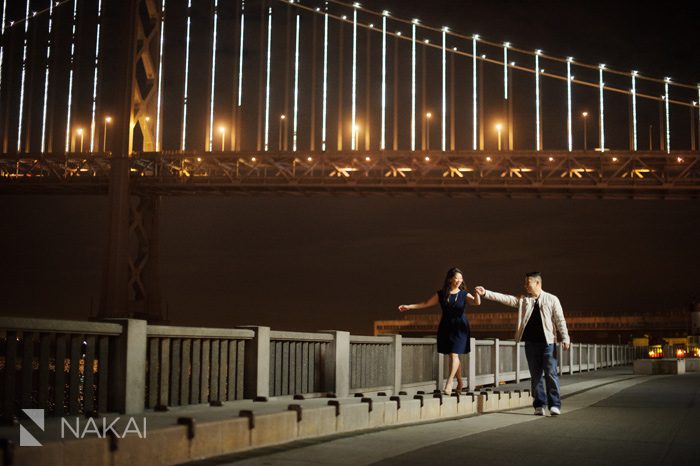 San Francisco bay bridge rincon park engagement picture at night