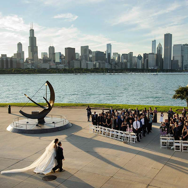 Adler Planetarium wedding venue, photo of bride walking down aisle, Chicago skyline in the background