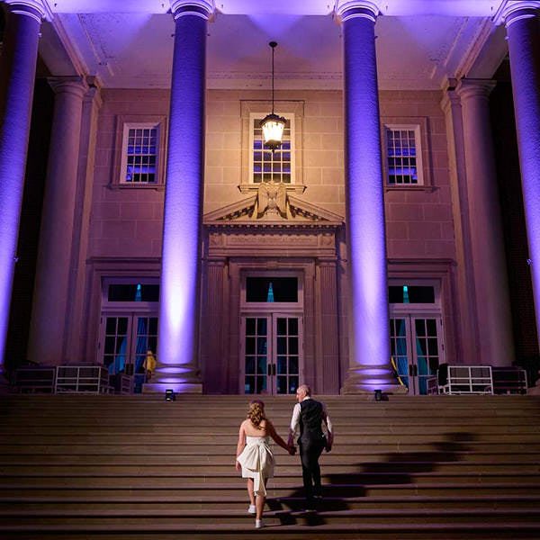 Chicago History Museum wedding venue photo with bride and groom walking up staircase at night