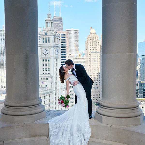 LondonHouse Chicago wedding photo. Couple kissing in Cupola w/skyline in background