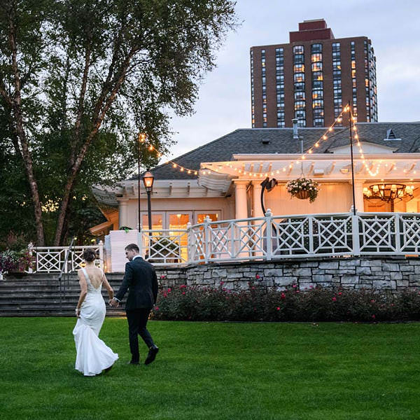Saddle and Cycle Wedding Venue photo with couple walking outside on the lawn