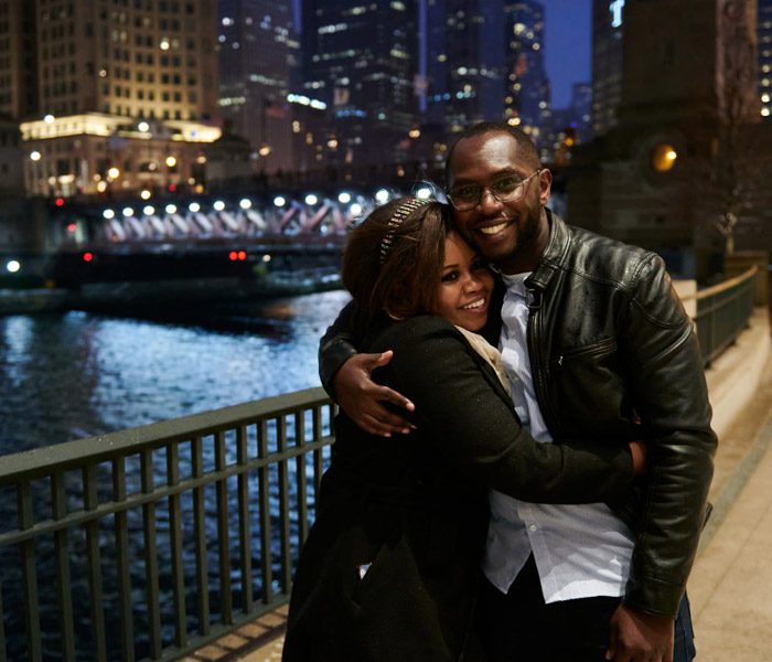chicago proposal night photos along riverwalk by Michigan Ave bridge. Hugging after the emotions