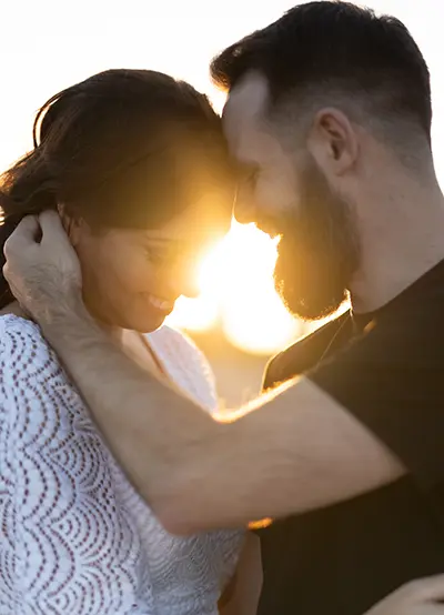 sunflare between smiling faces chicago sunset engagement photo