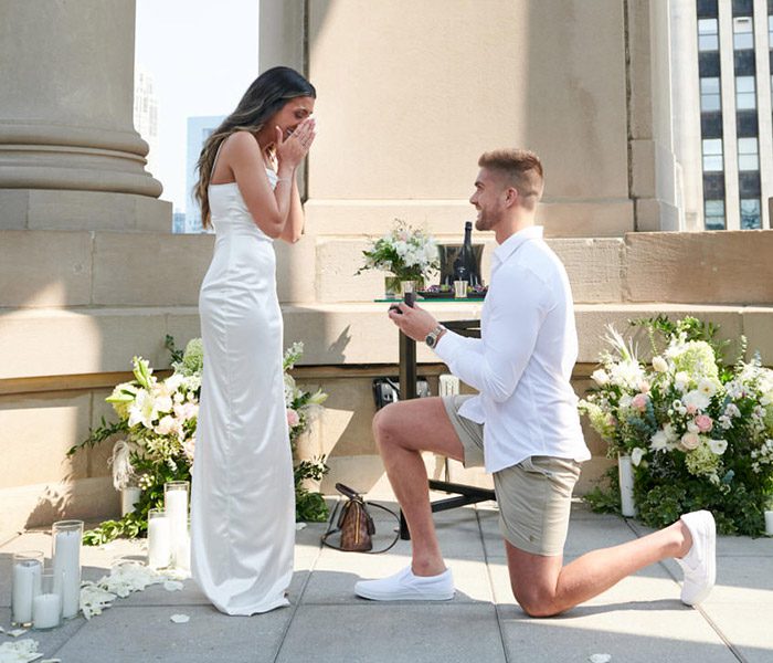 Chicago LondonHouse proposal photographer in Cupola on rooftop. He is on bended knee, she is emotional.