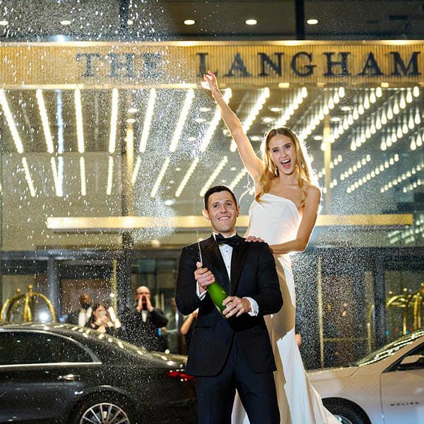 the langham chicago wedding photo bride groom spraying champagne
