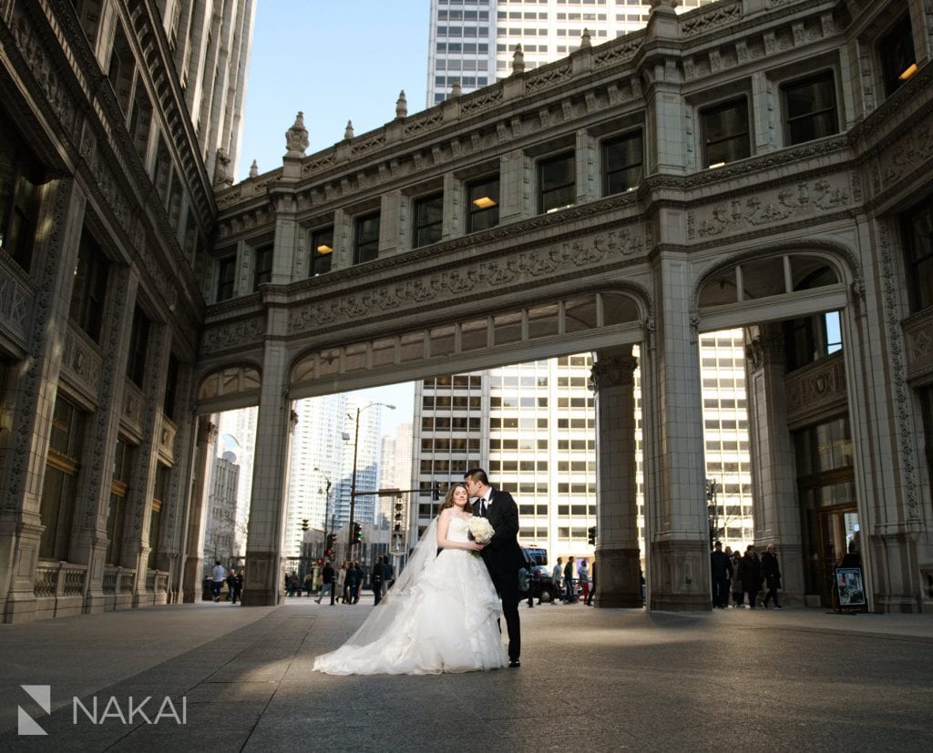 Wrigley building Chicago wedding photo bride groom kiss