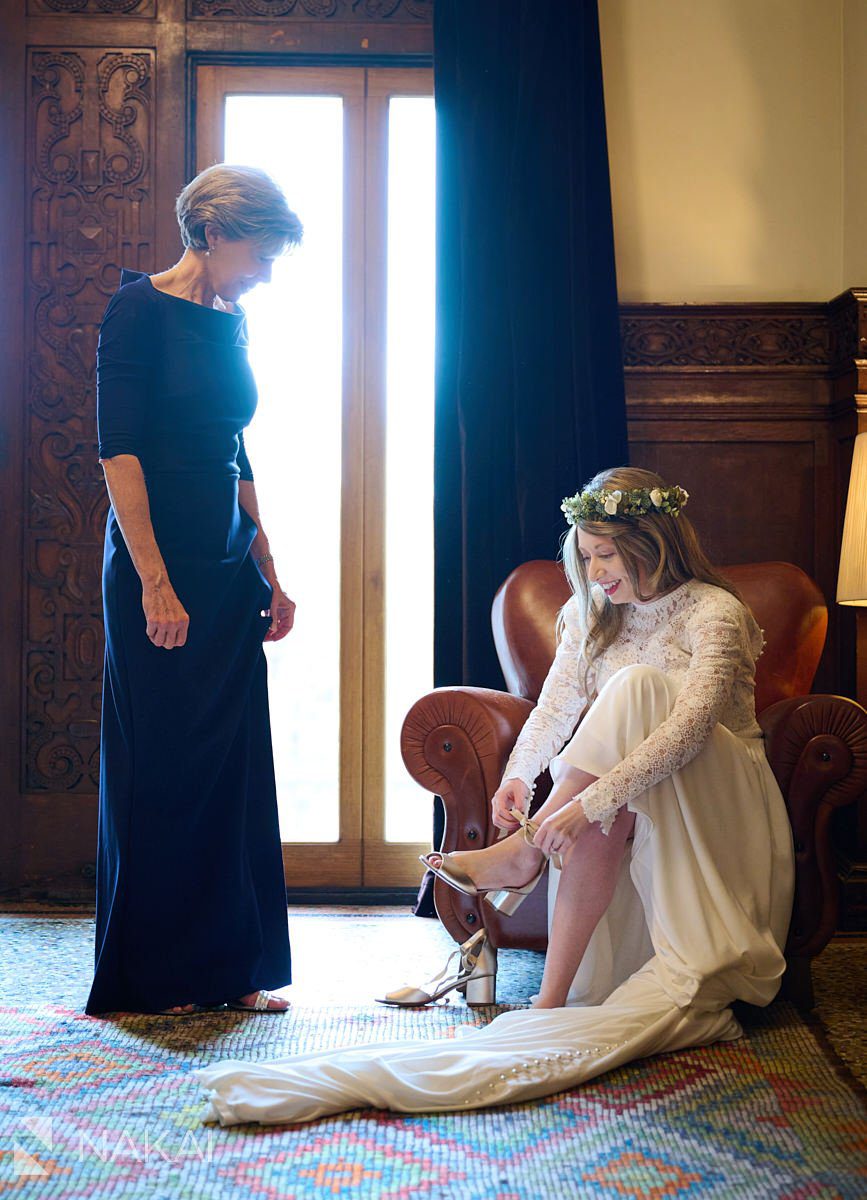 Chicago athletic association hotel wedding photos getting ready mother of bride helping put on shoes