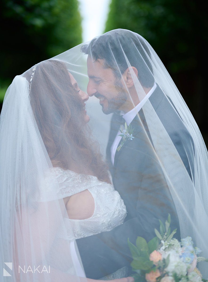 chicago botanic garden wedding photos veil bride and groom between trees