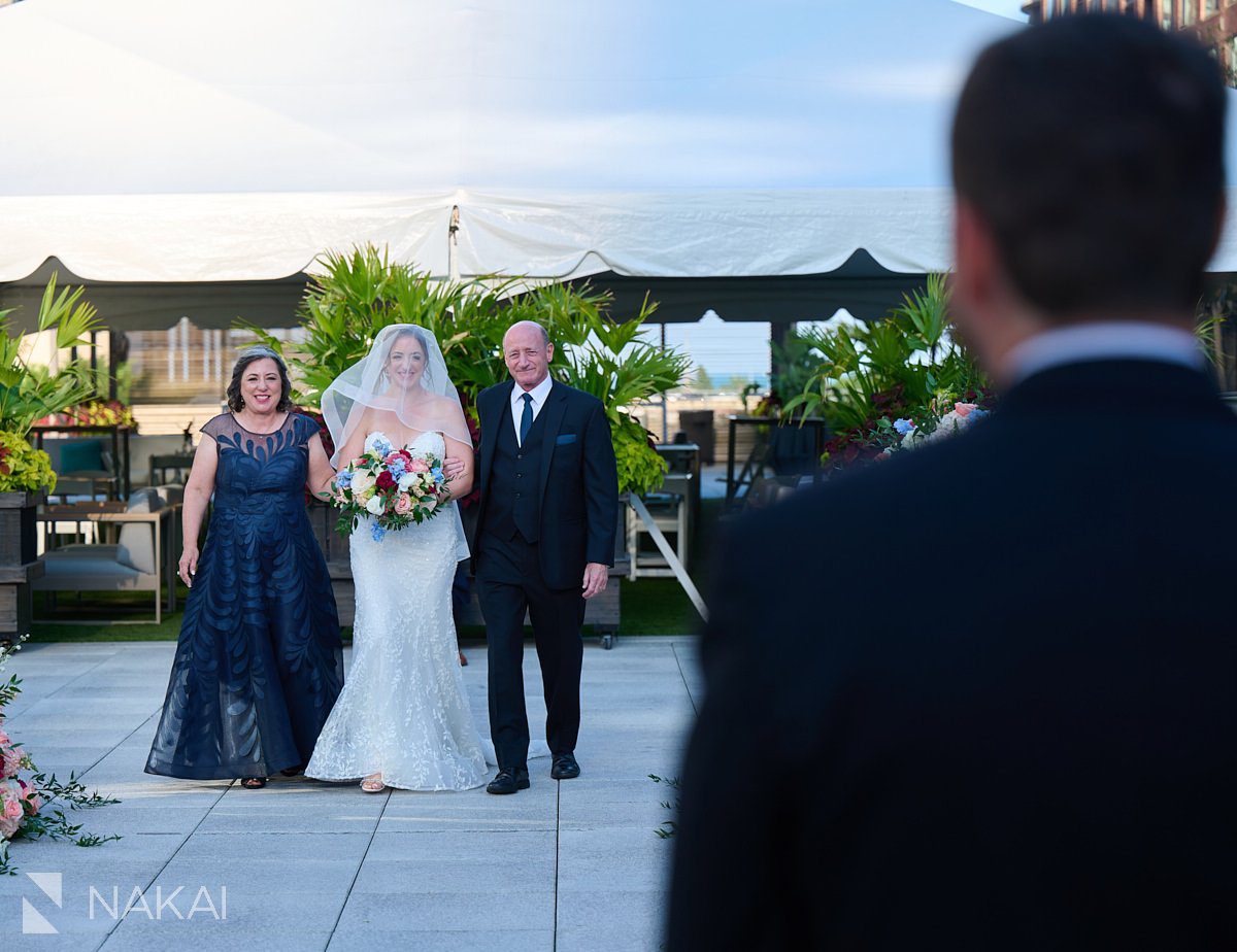 Loews Chicago Wedding pictures rooftop ceremony on terrace bride down the aisle