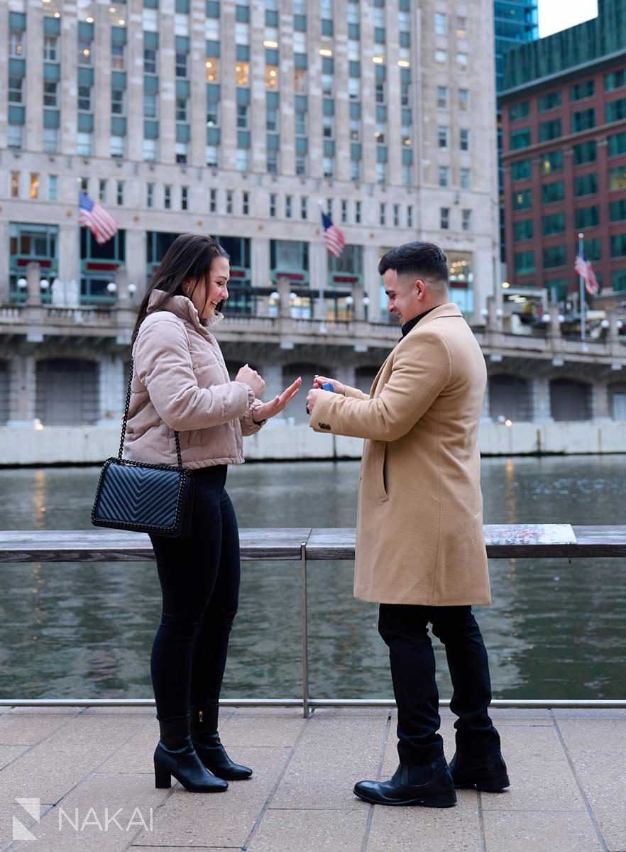 riverwalk Chicago proposal photos putting ring on