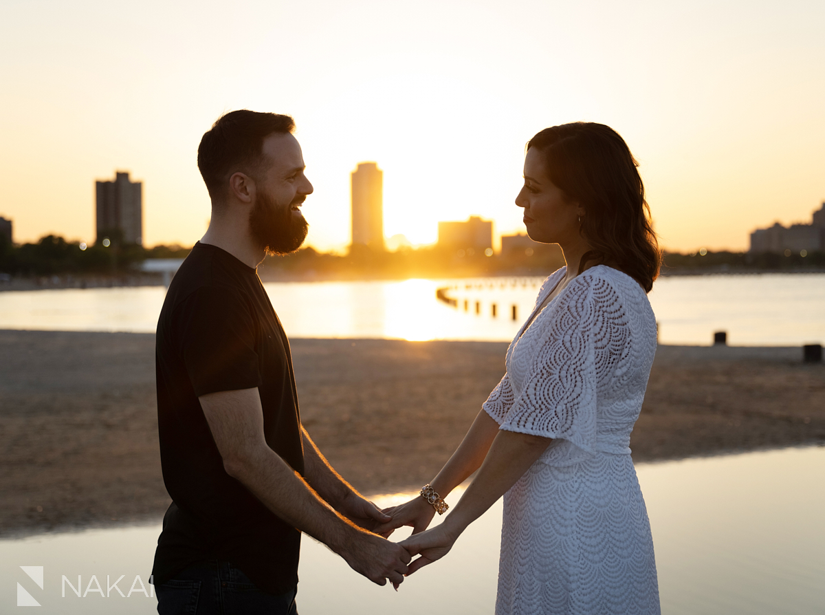 Engagement photo shoot chicago north ave pier holding hands at sunset