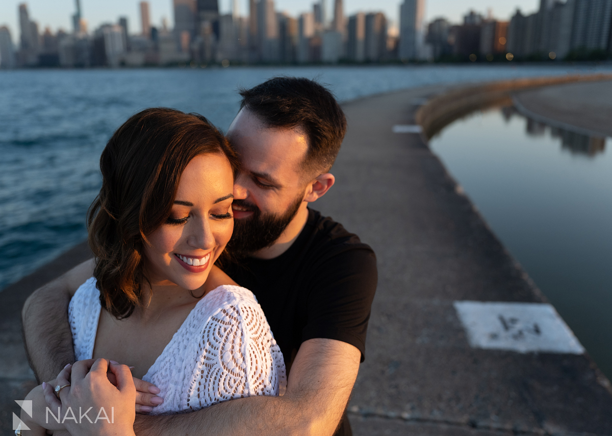 Engagement photo shoot chicago north ave pier embrace at sunset