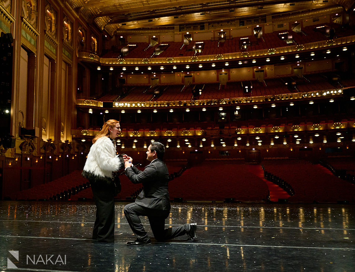Chicago proposal photographers surprise on stage at Lyric Opera on bended knee 
