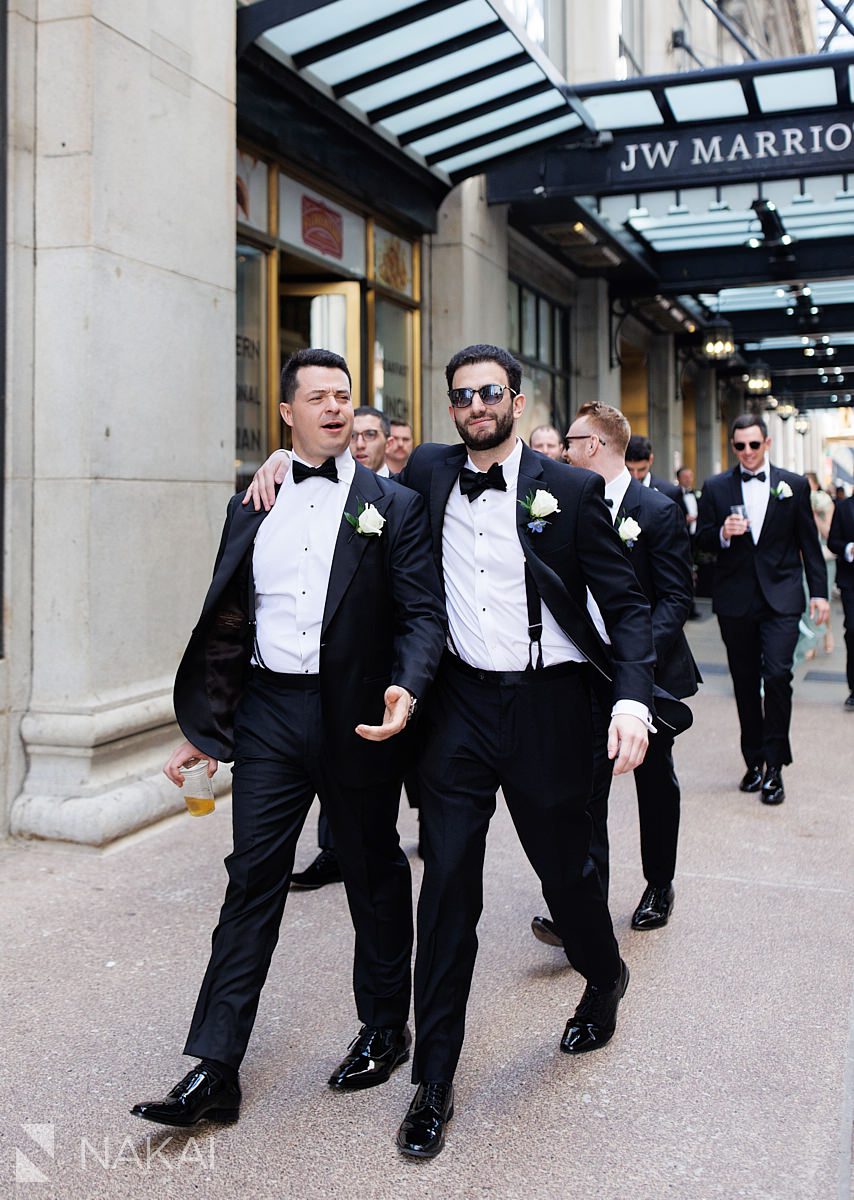 groom walking with groomsman outside JW Marriott Chicago wedding 