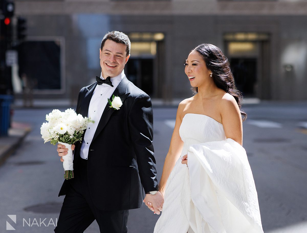 bride groom walking and smiling Chicago LaSalle Street wedding photos