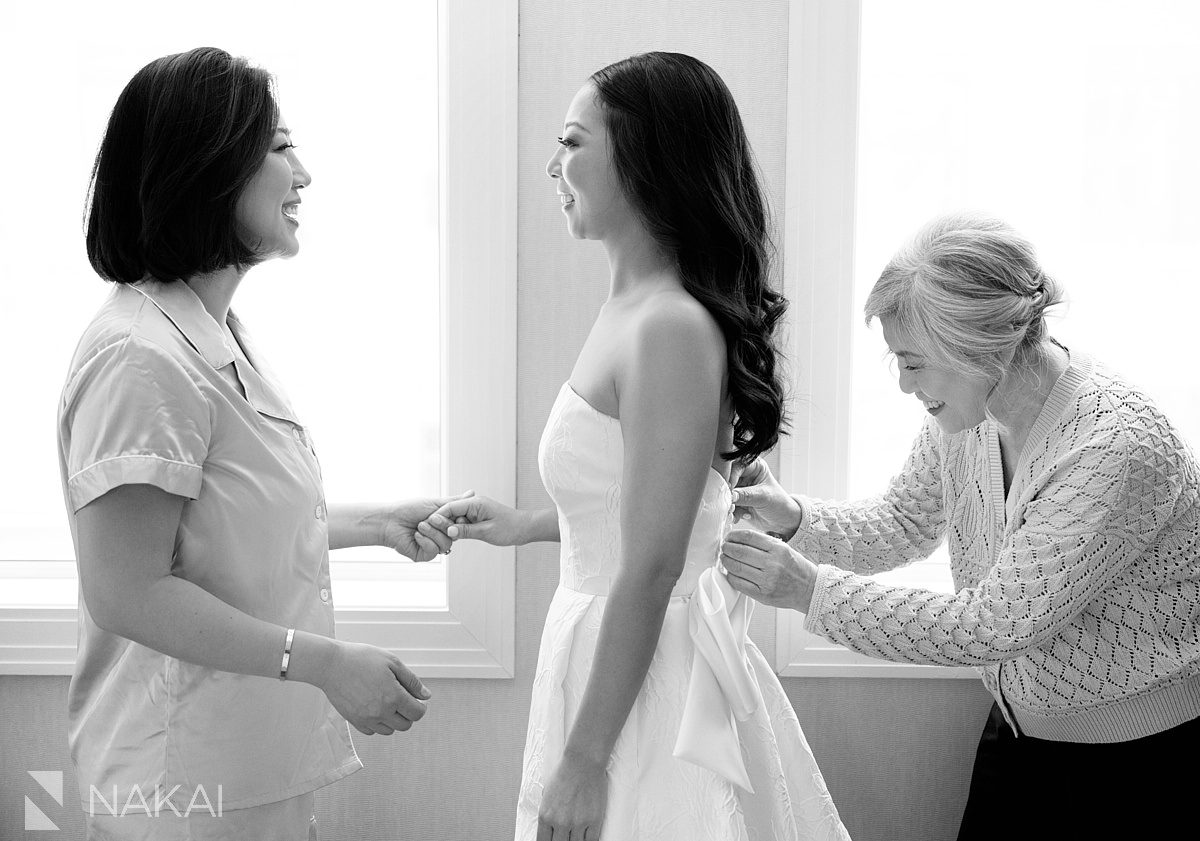 bride with sister and mom getting dress on at JW Marriott Chicago
