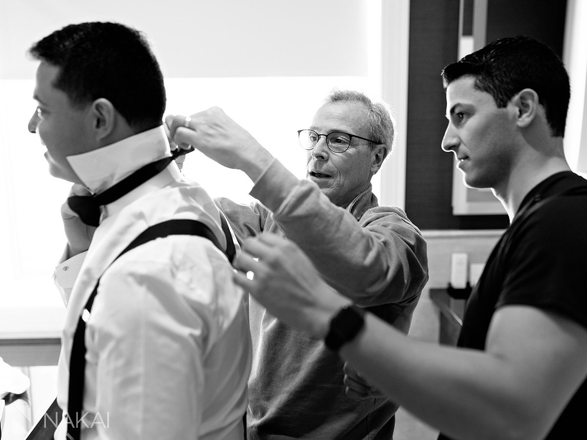 father and brother helping dress groom for JW Marriott Chicago wedding