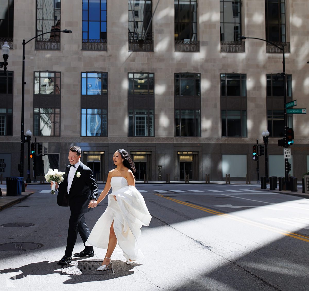 LaSalle St Chicago wedding photos bride groom walking in sunlight