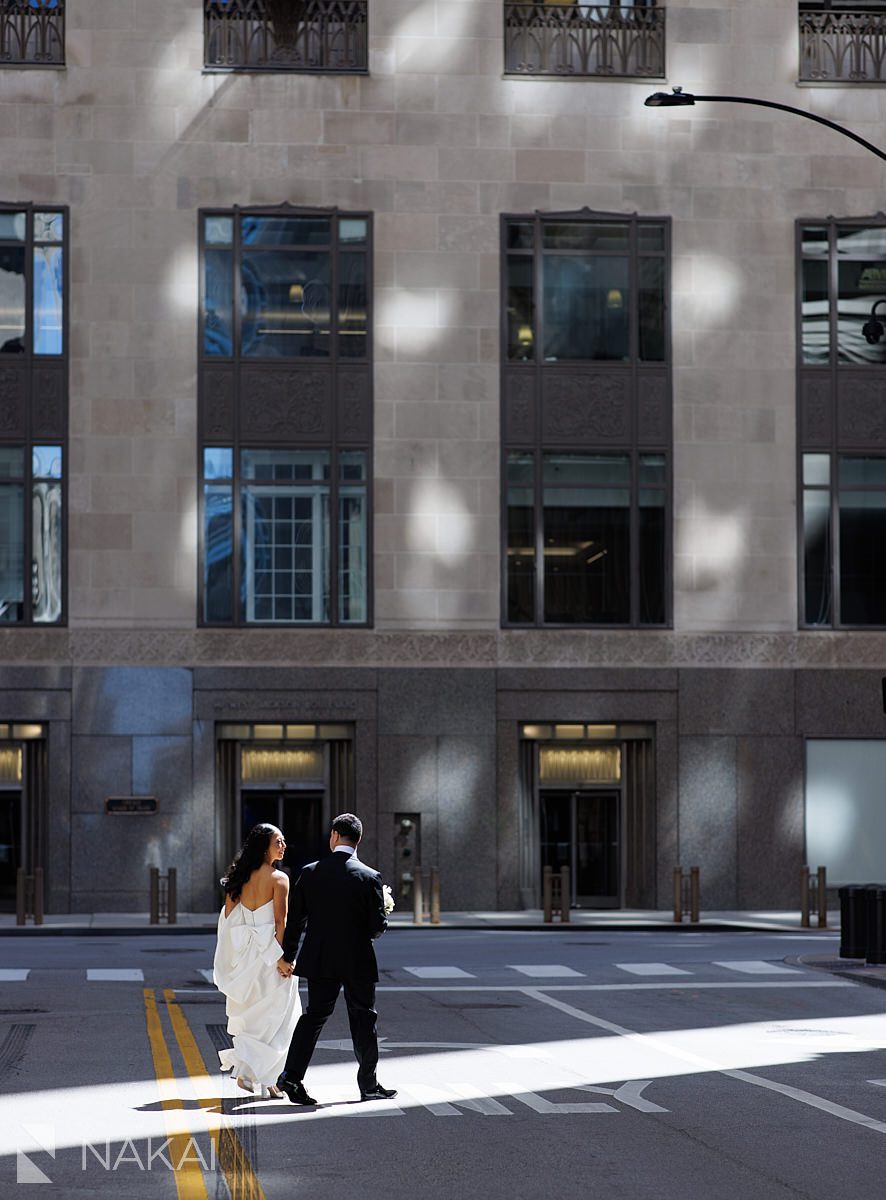 bride groom walking in sunshine LaSalle Street chicago wedding pictures 