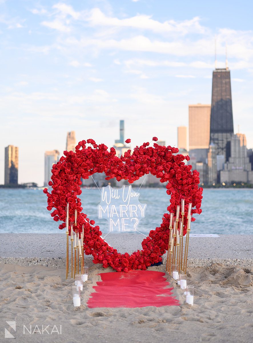 Great engagement proposal ideas Chicago: flower wall heart wreath backdrop with skyline in the background