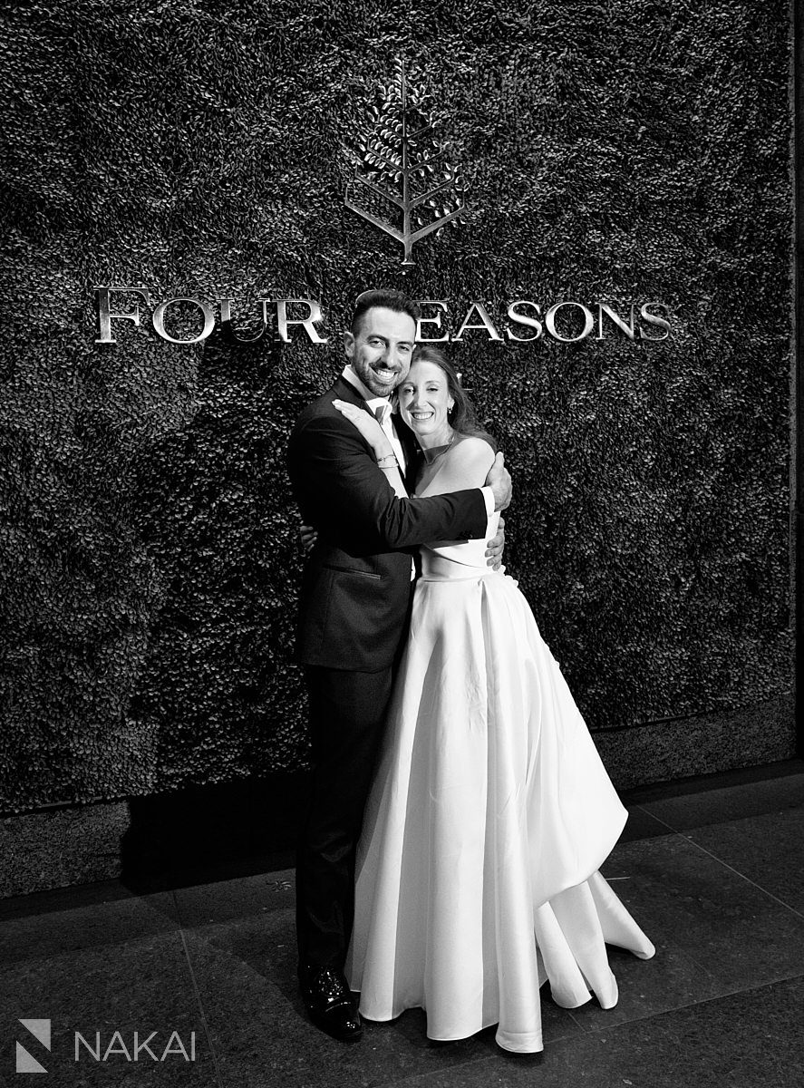 night shots Four Seasons Hotel Chicago wedding photo in front of sign