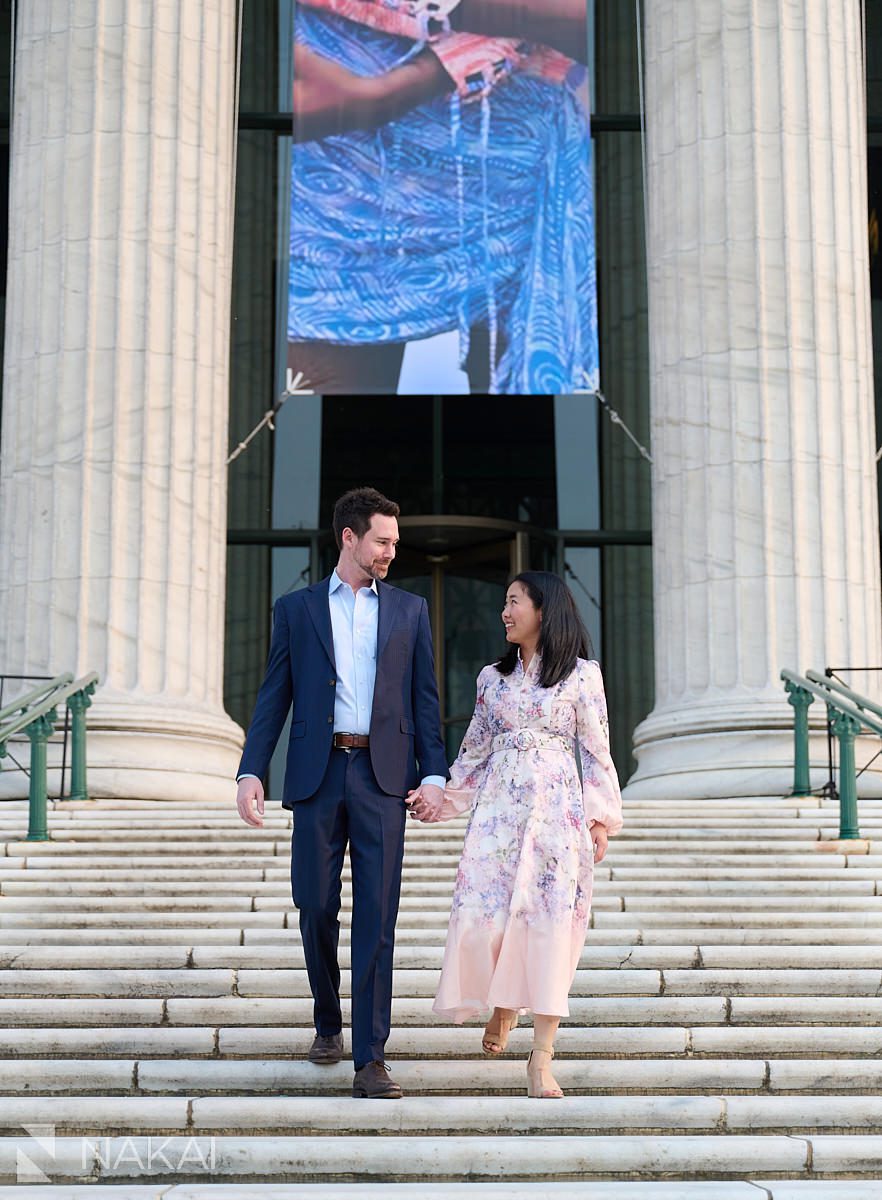 chicago museum campus engagement photos walking down front steps holding hands