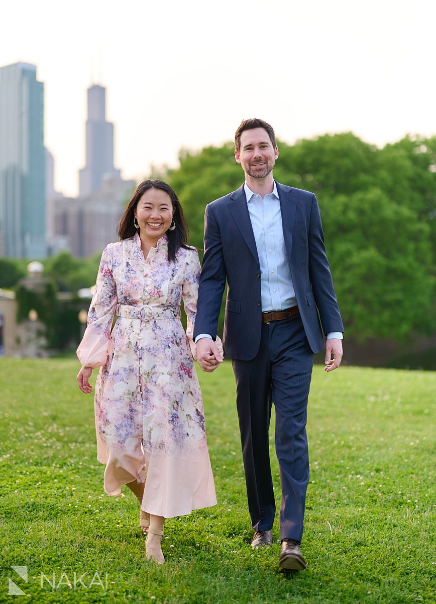 museum campus engagement photos walking on grass holding hands laughing