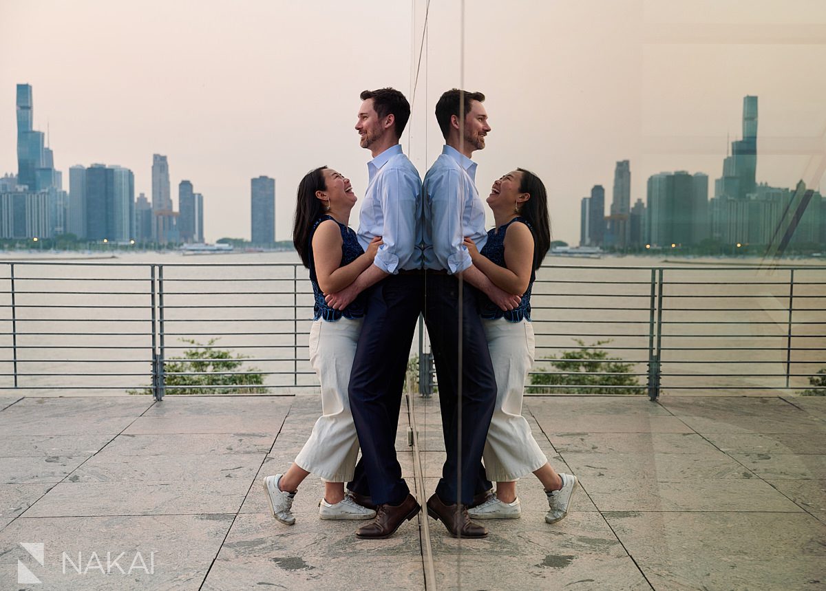 museum campus engagement photos reflection of laughing couple in glass