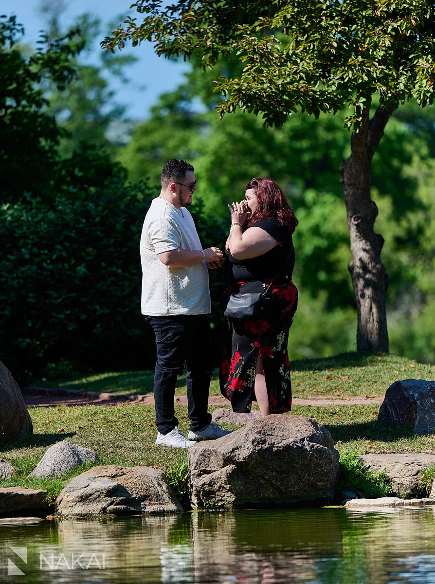 Proposal photos at garden of phoenix, putting on the ring in Chicago's Hyde Park