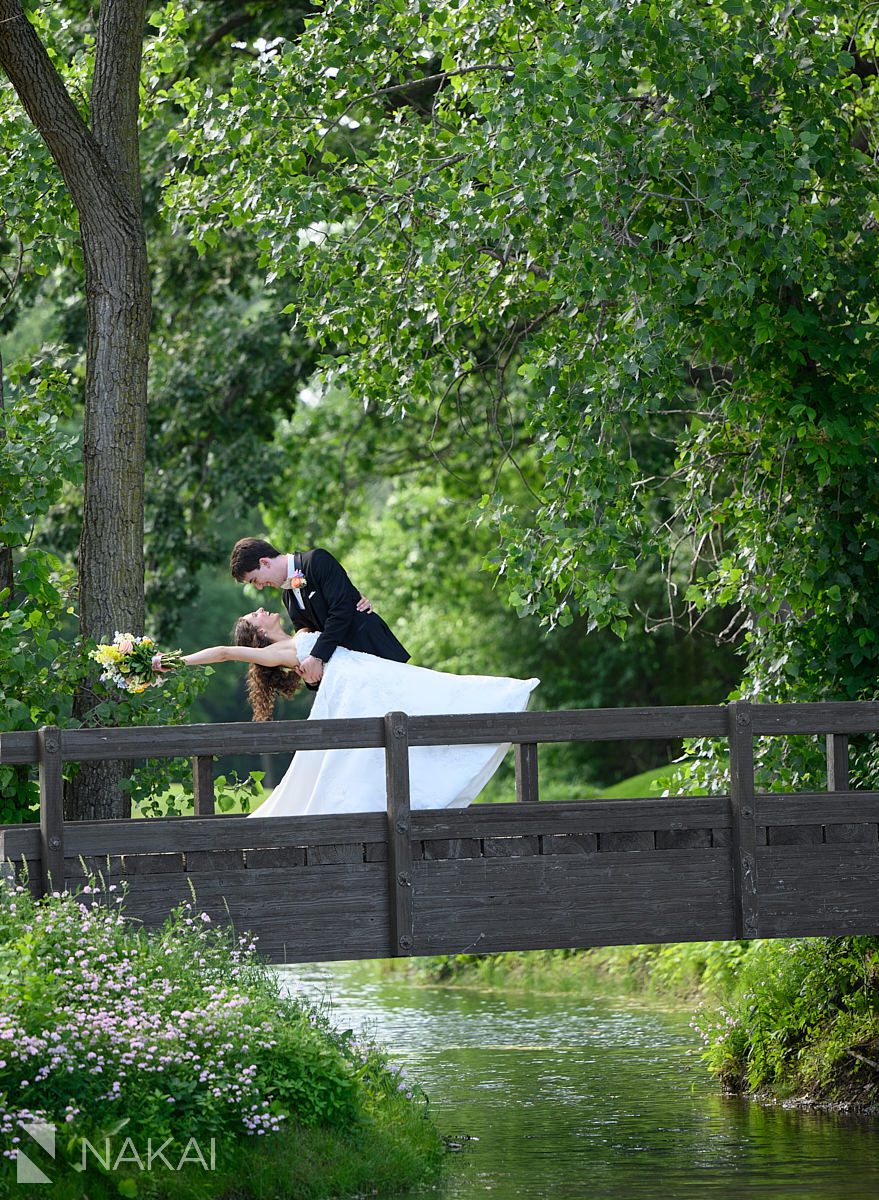 Ravinia Green Country Club Wedding couple dip on bridge