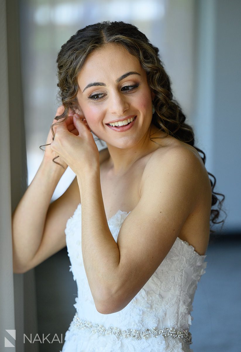 Ravinia Green Country Club Wedding getting ready bride putting on earring