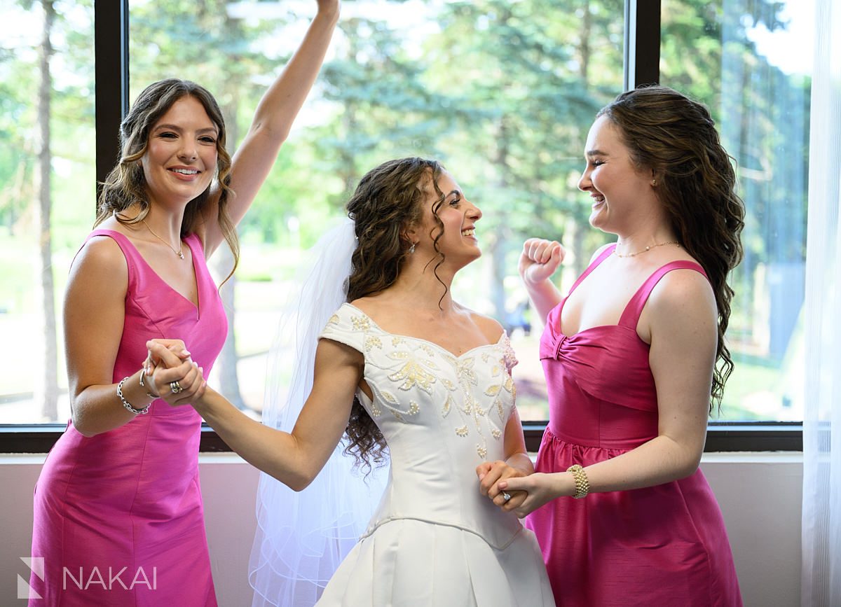 Ravinia Green Country Club Wedding bridesmaids helping with dress