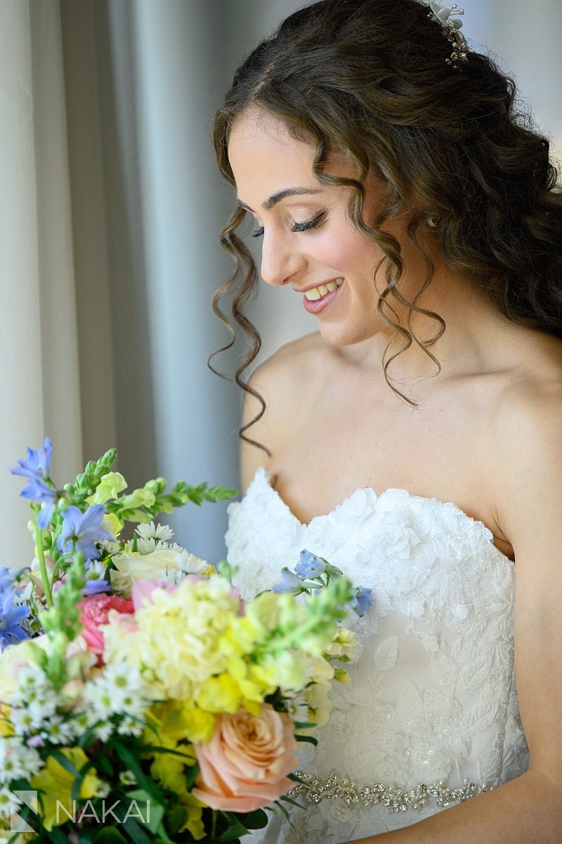 bride Ravinia Green Country Club Wedding looking at flowers