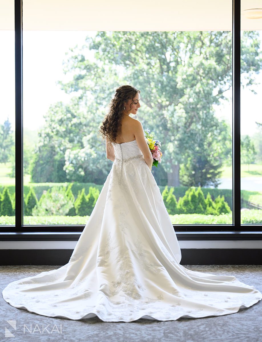 bride Ravinia Green Country Club Wedding standing in front of window