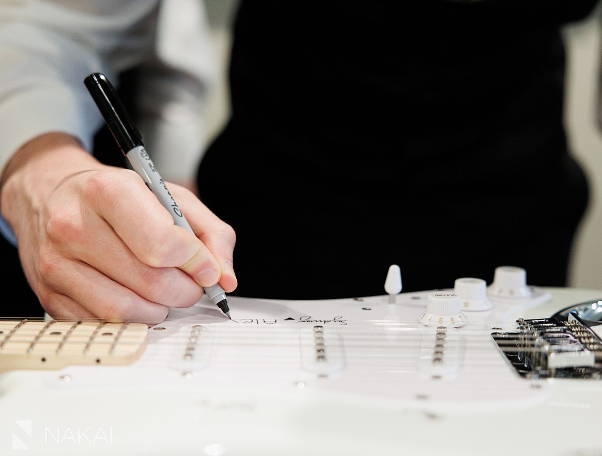guys Ravinia Green Country Club Wedding signing guitar