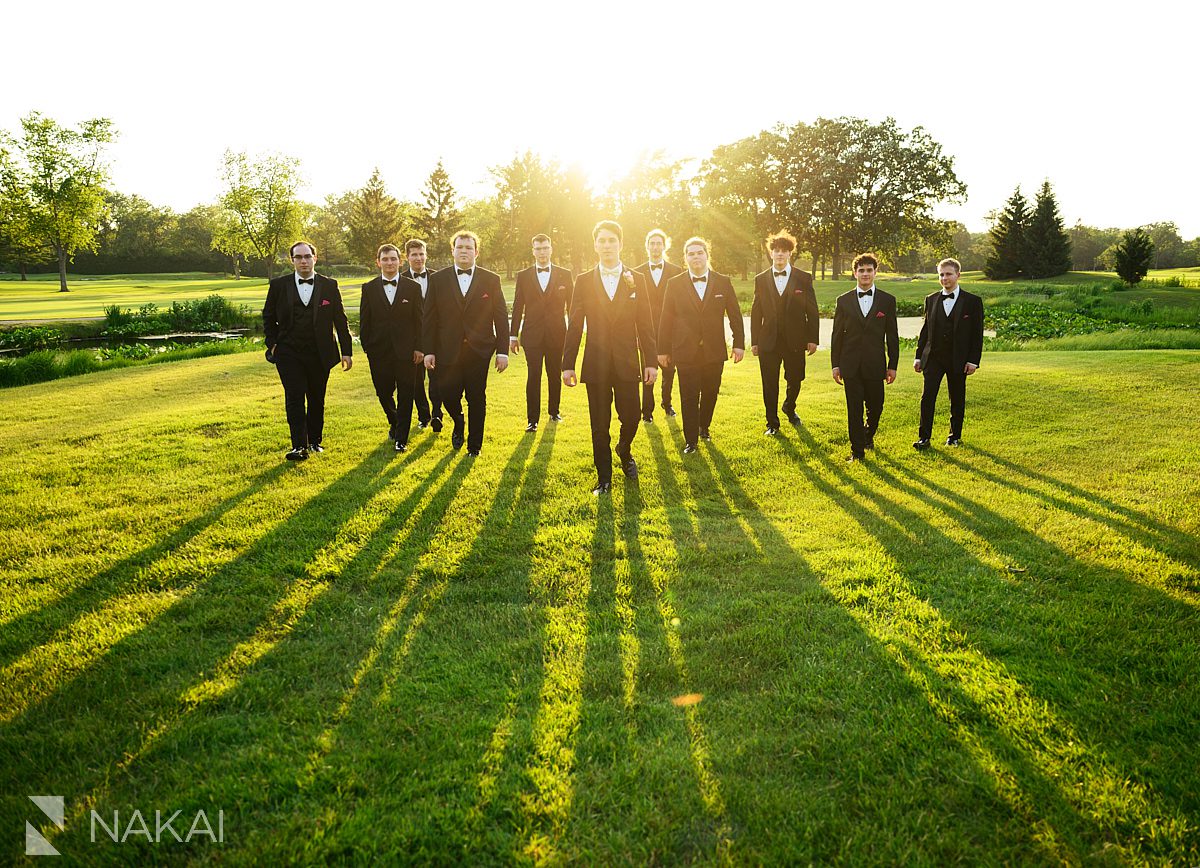 sunset Ravinia Green Country Club Wedding groomsmen walking 