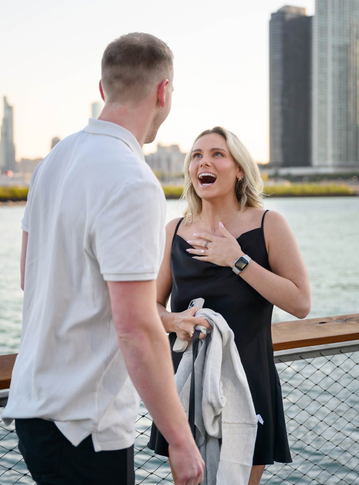 navy pier proposal happy emotions, hand on her chest