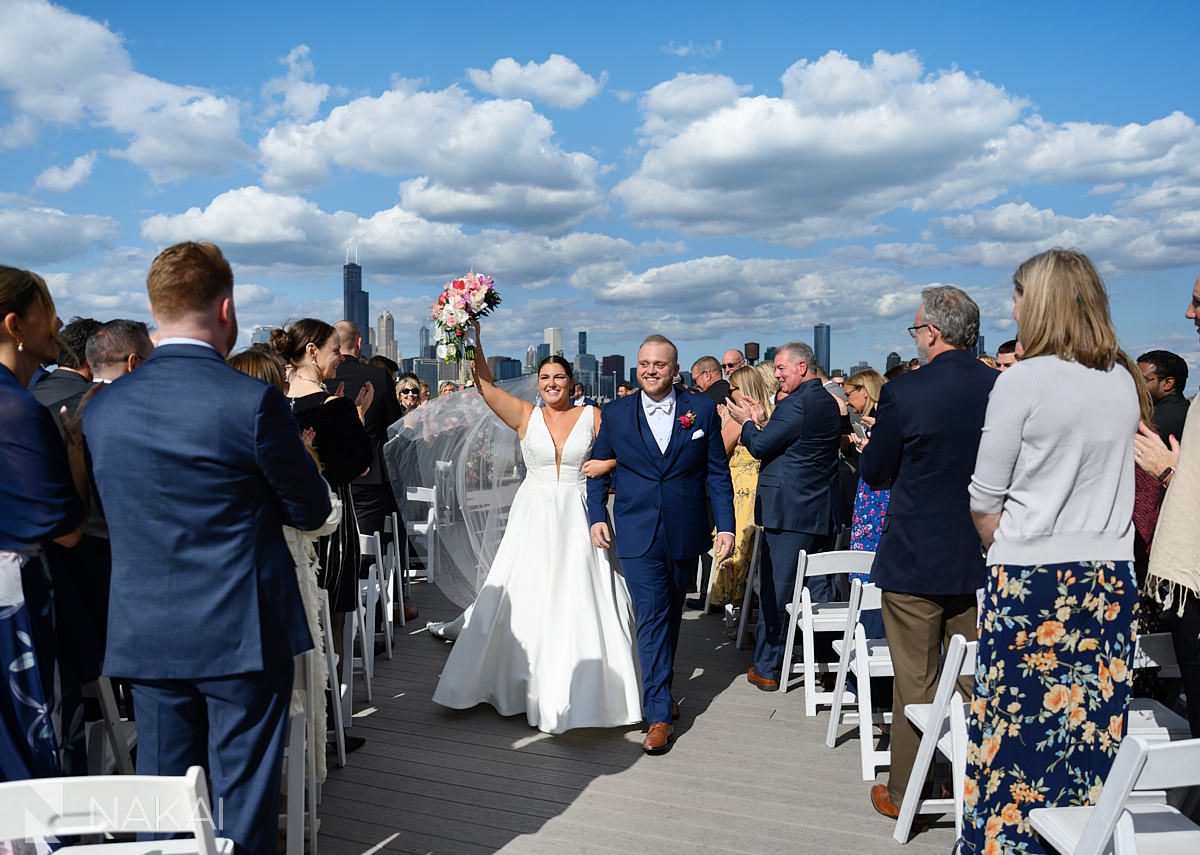 lacuna lofts wedding chicago rooftop ceremony exit bride and groom