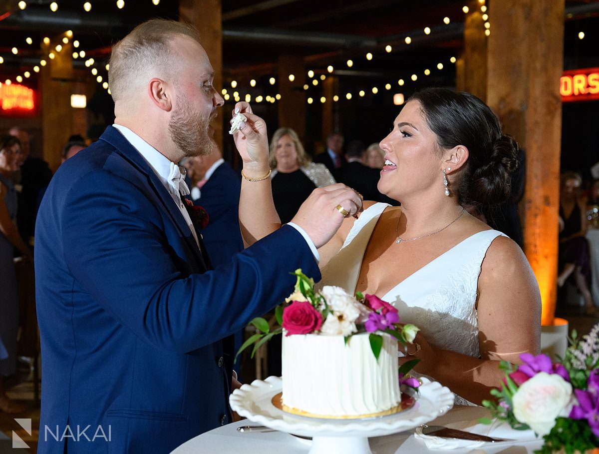 lacuna lofts wedding reception program feeding cake