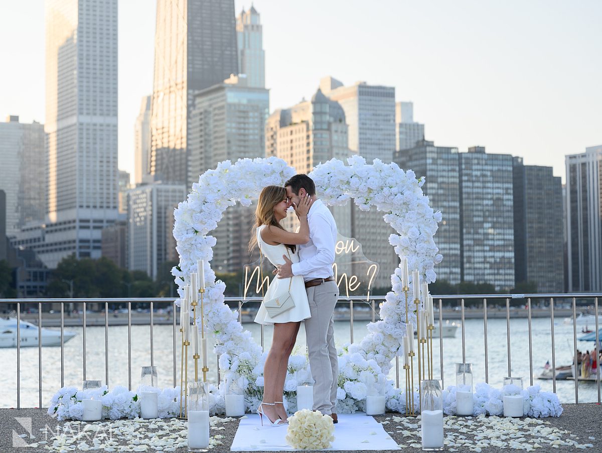 sunset chicago proposal spots at Olive Park white flower arch heart shaped in background