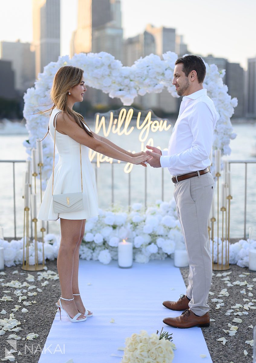 sunset chicago proposal spots at Olive Park white flower arch heart shaped in background