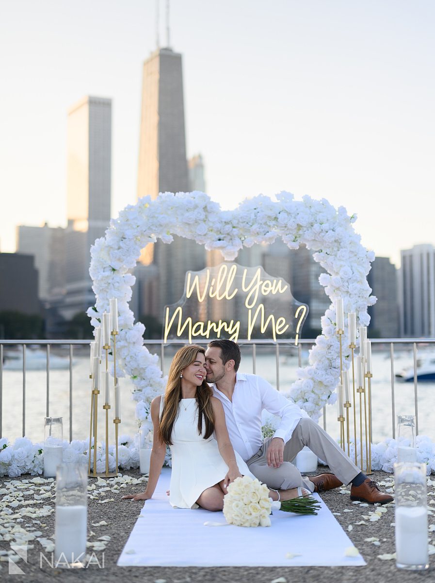sunset chicago proposal spots at Olive Park white roses arch heart shaped in background