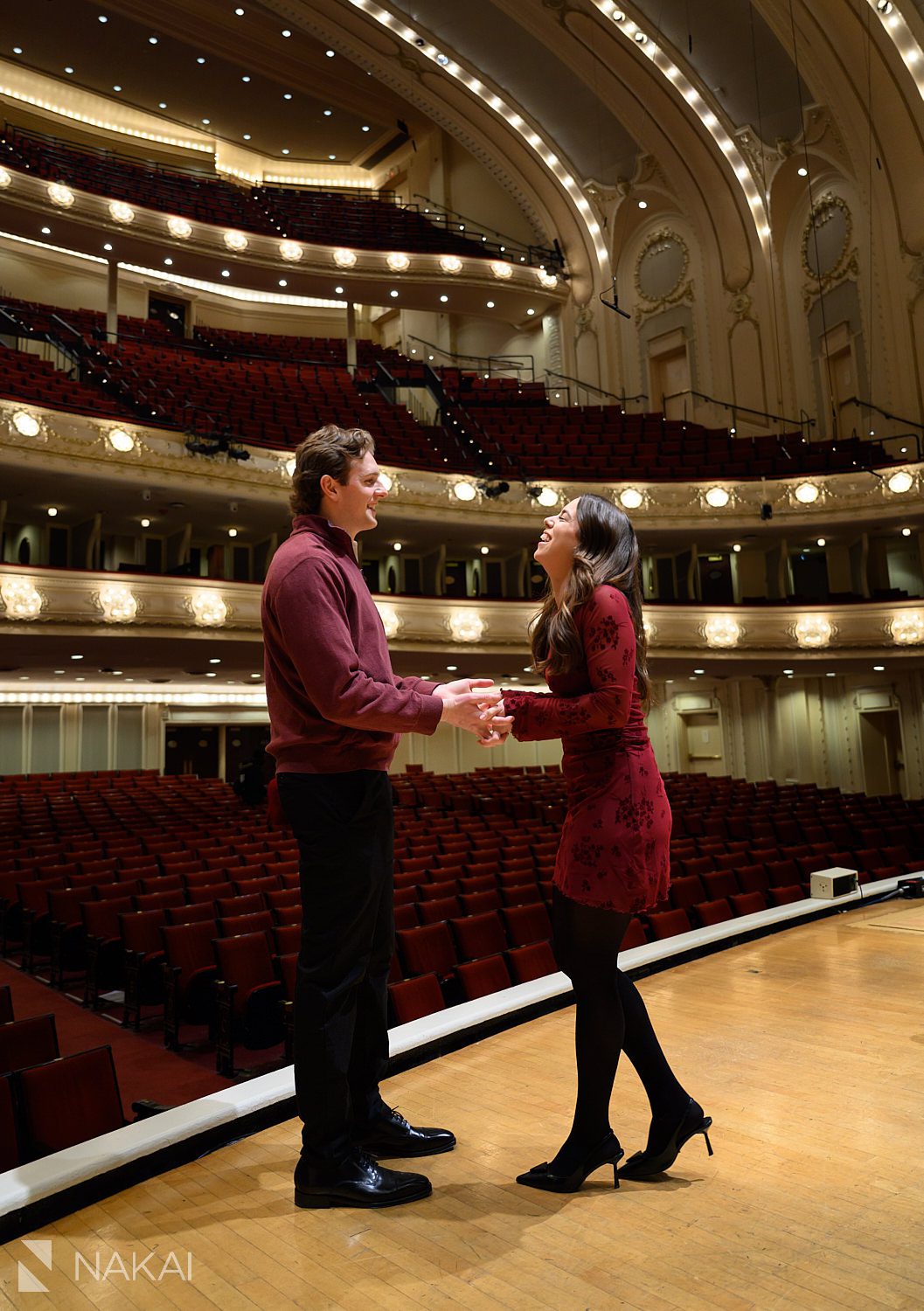couple on stage holiday chicago winter proposal idea at Symphony Center