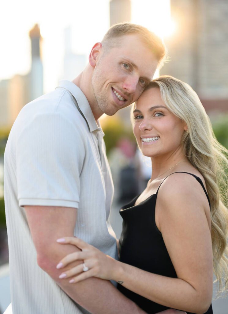 couple looking at camera with sunflare captured by their proposal photographer chicago