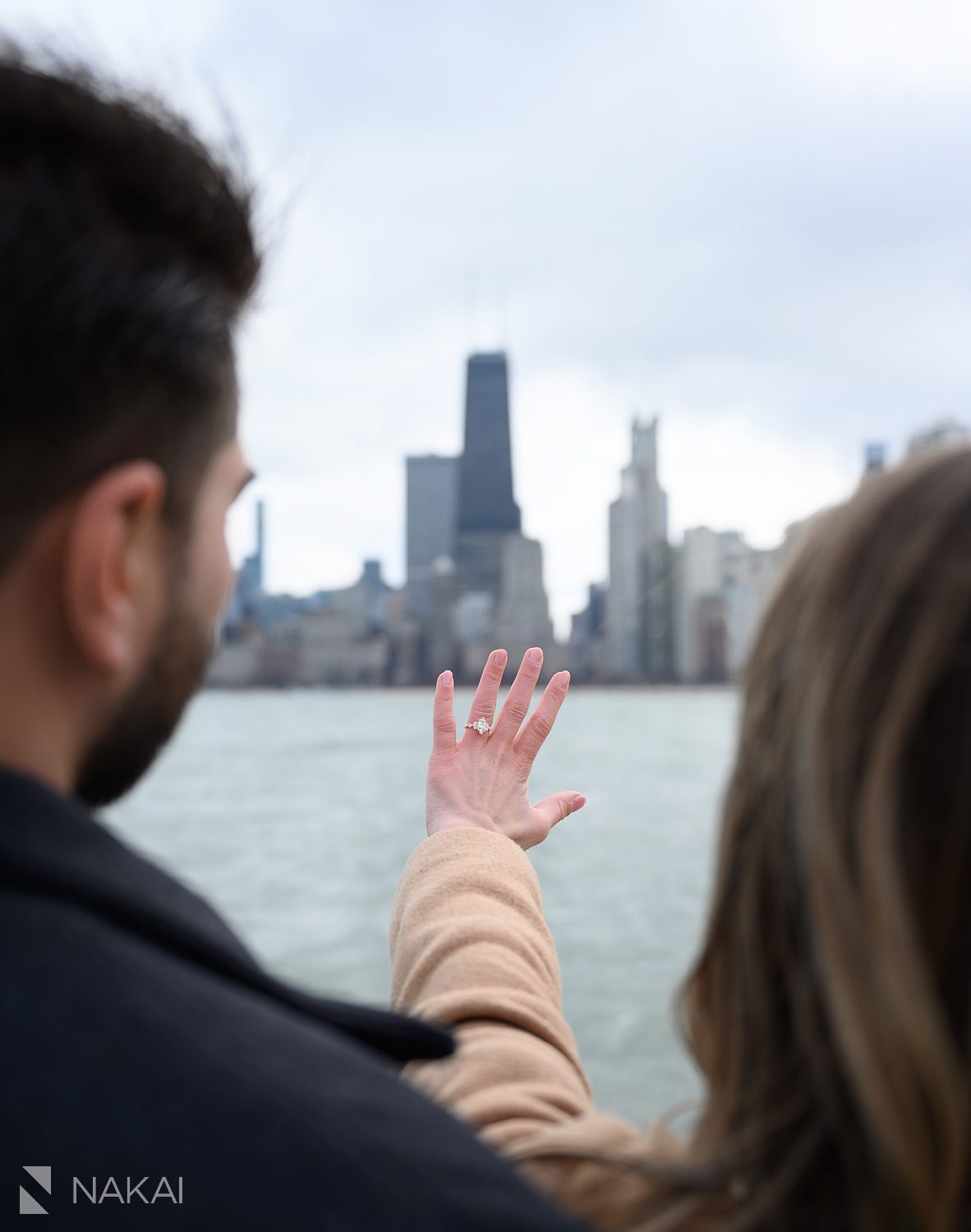 north ave beach proposal chicago ring on hand looking at skyline