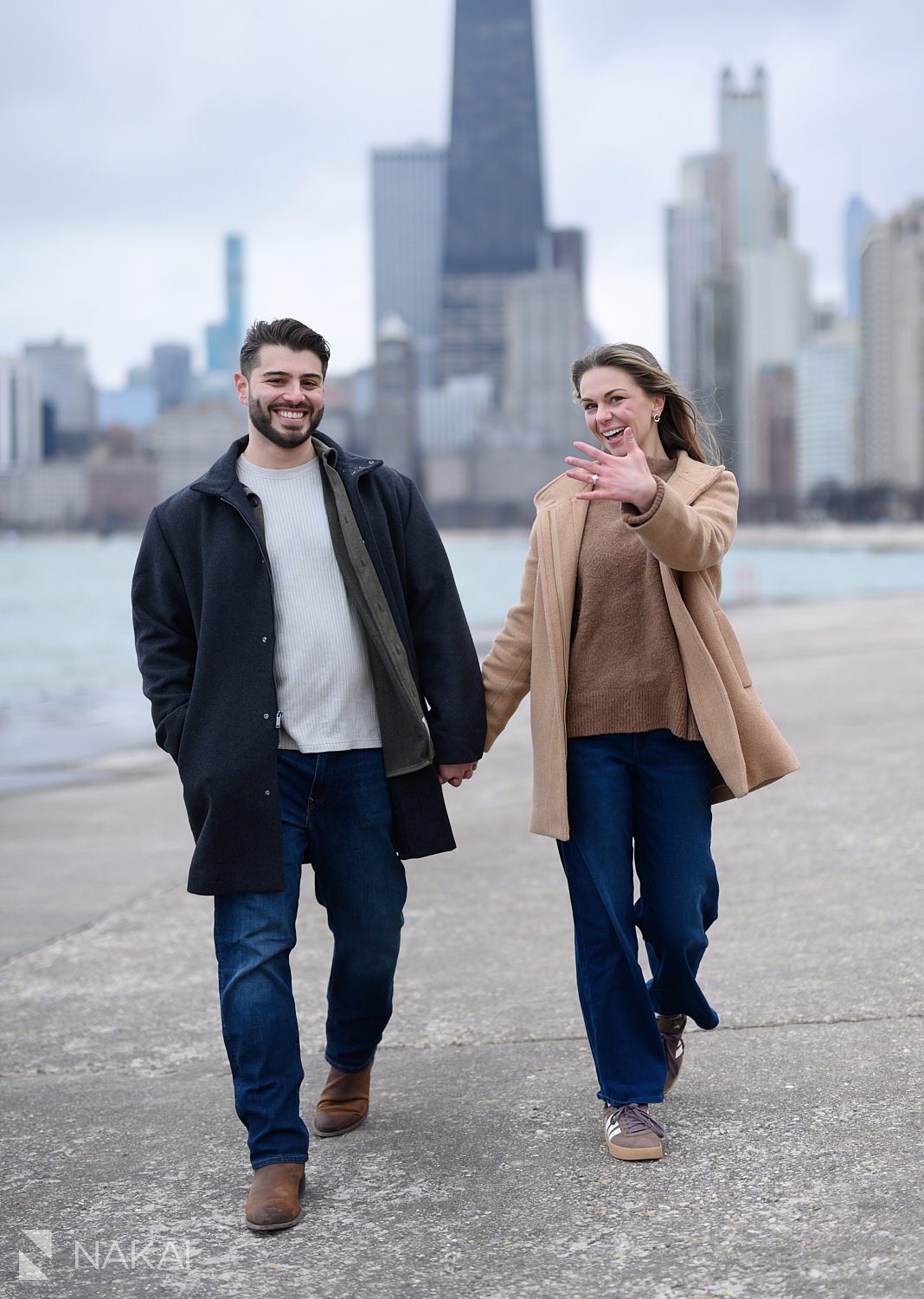 walking showing off ring on her hand during north ave beach proposal