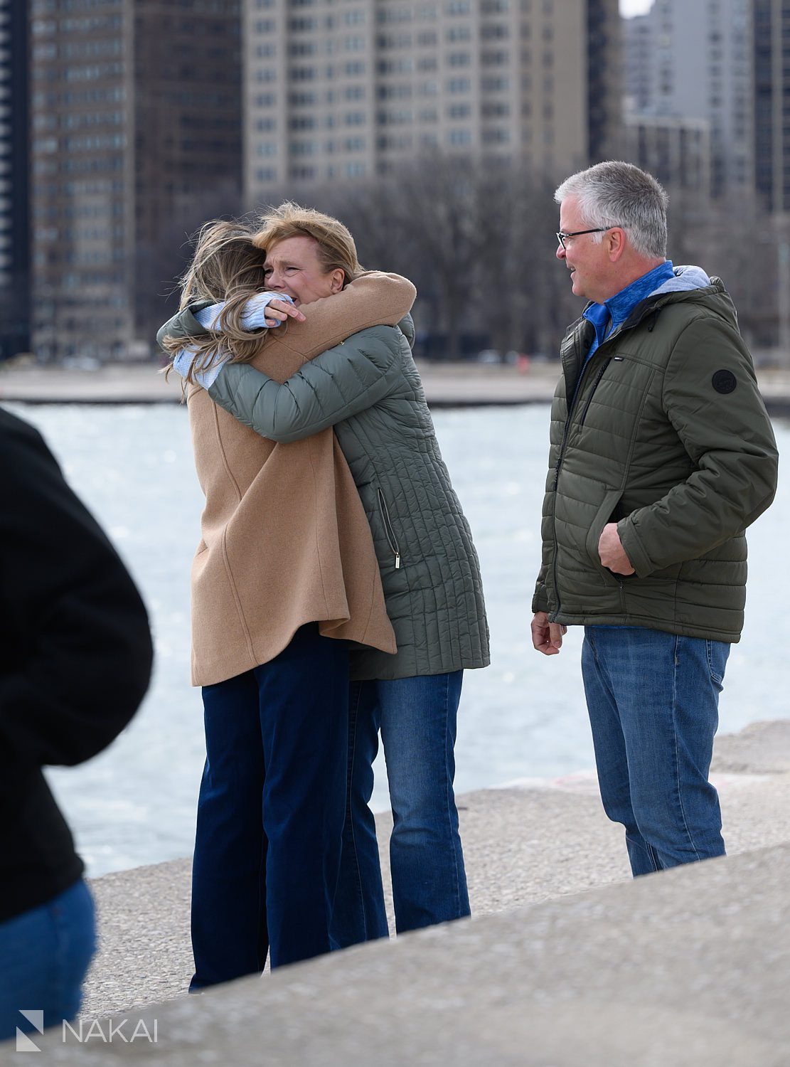 hugging parents surprise daughter at proposal