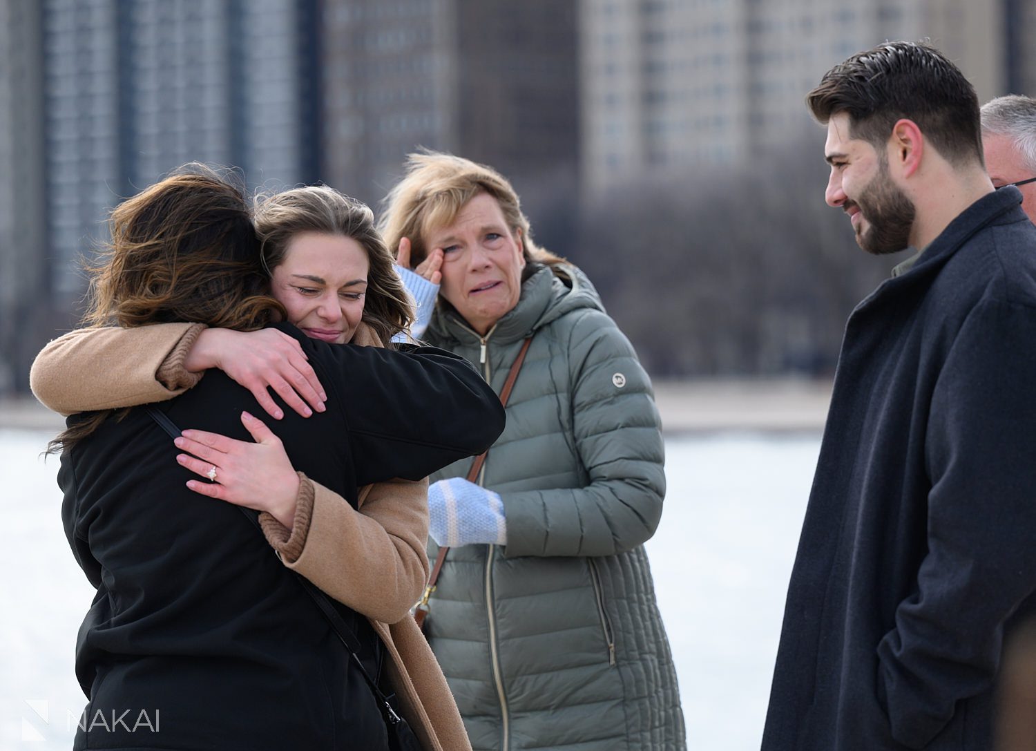 hugging parents surprise daughter at proposal