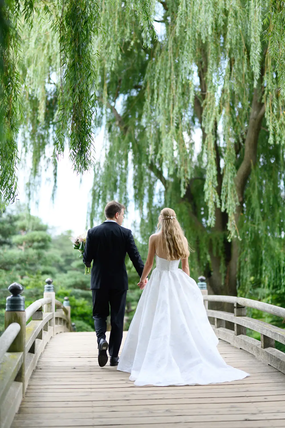 chicago botanic garden wedding couple walking on bridge holding hands